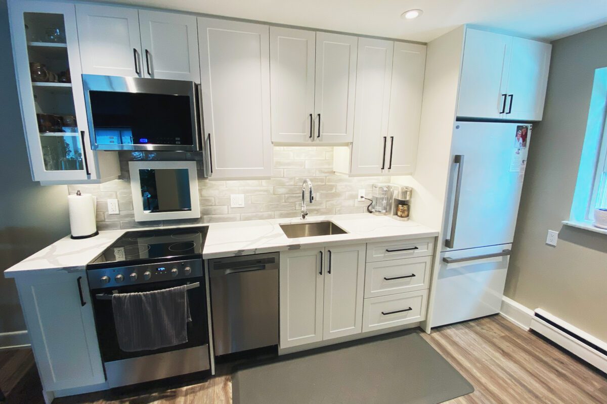 A full kitchen with marble style countertop and open concept.