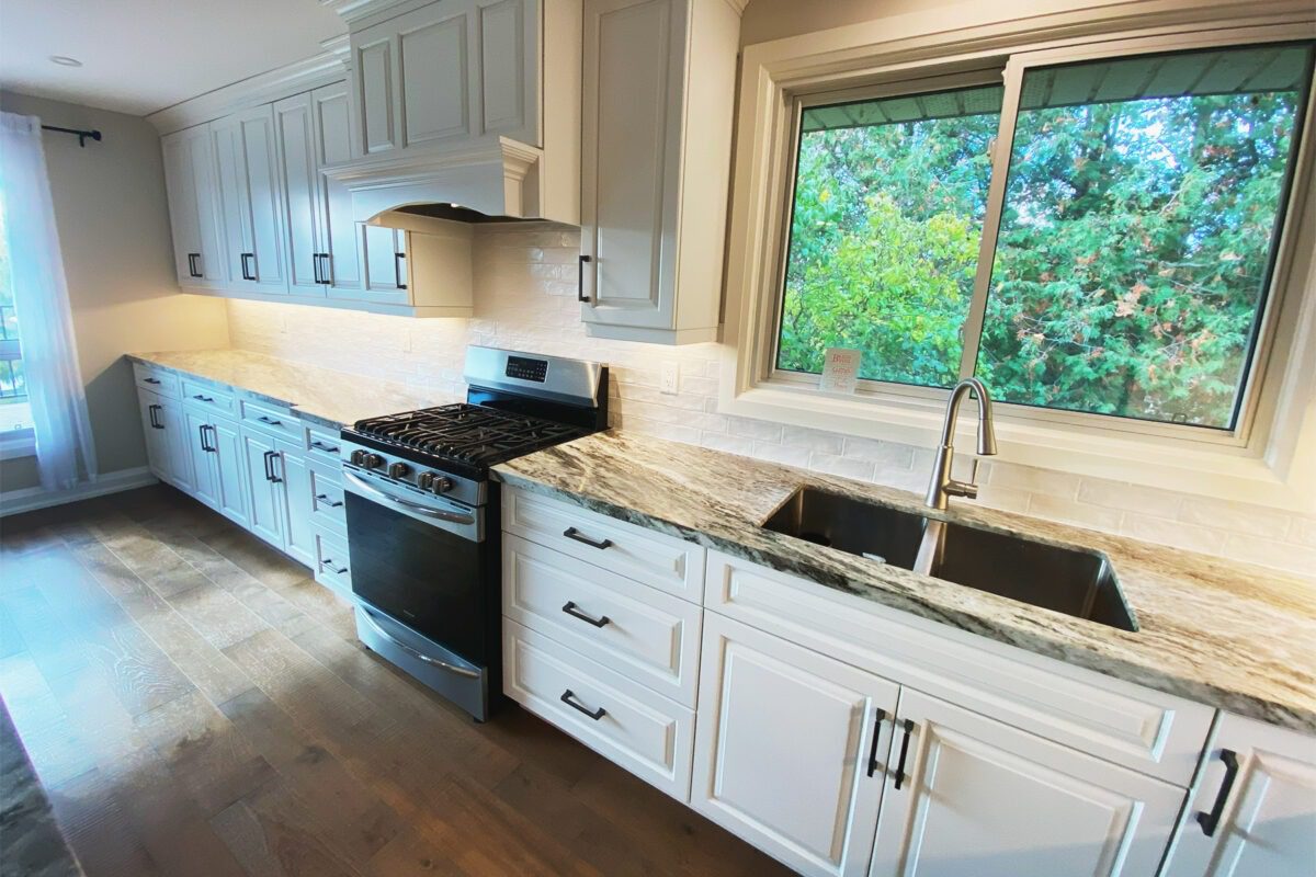 A renovated kitchen with windows and a new backsplash.