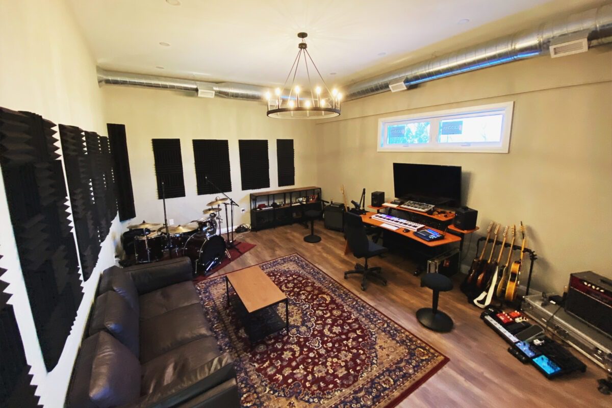 Inside a sound studio with instruments and equipment around.