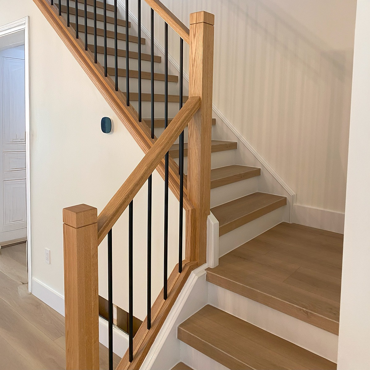 A wooden staircase with one landing.